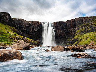 Gufufoss waterfall flowing thourgh rocks in summer at Seydisfjor